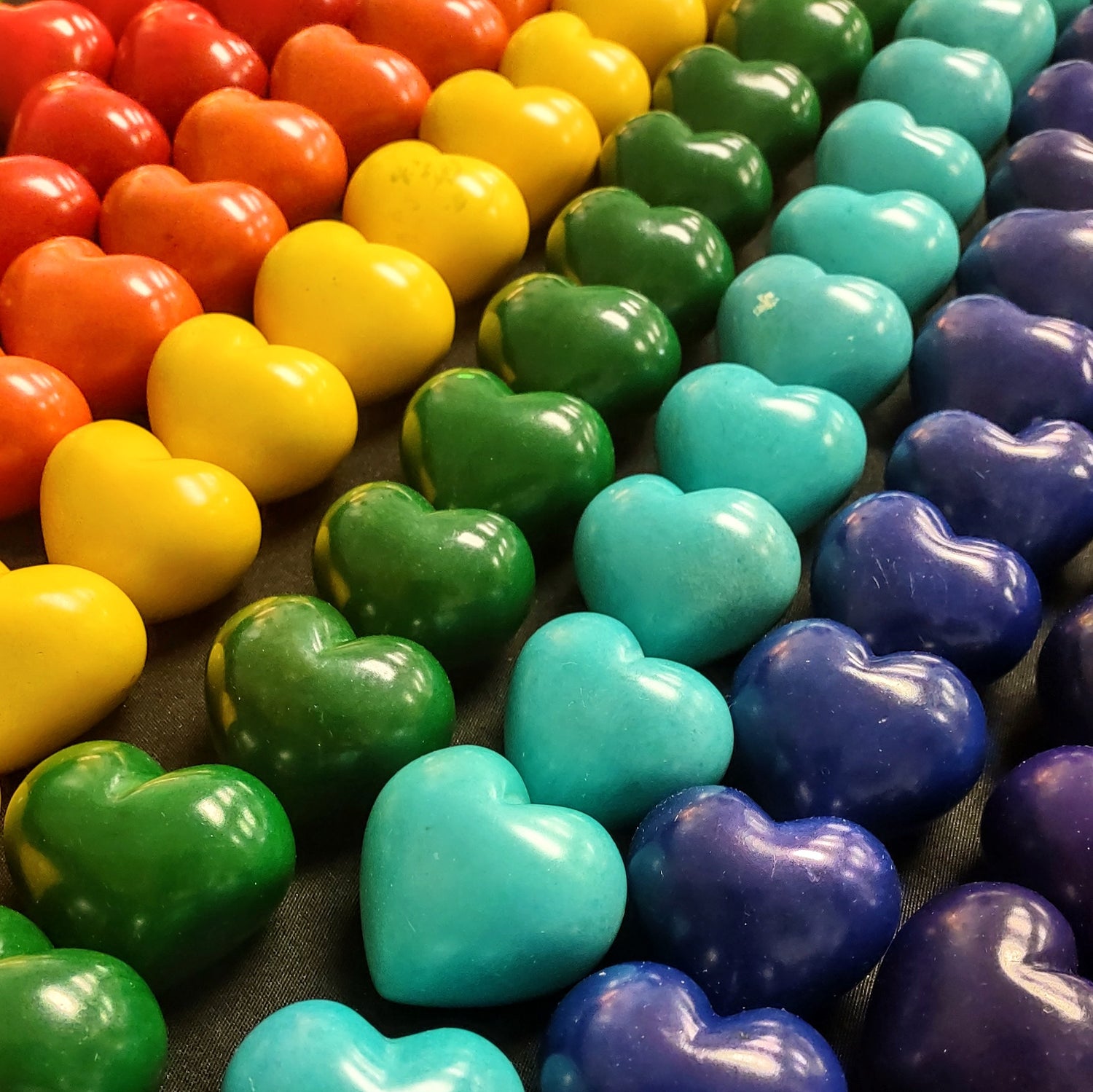 rows of small soapstone hearts arranged in a rainbow pattern